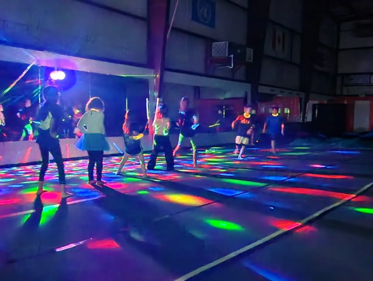 Kids dancing at glow party during summer camp in Waco Texas