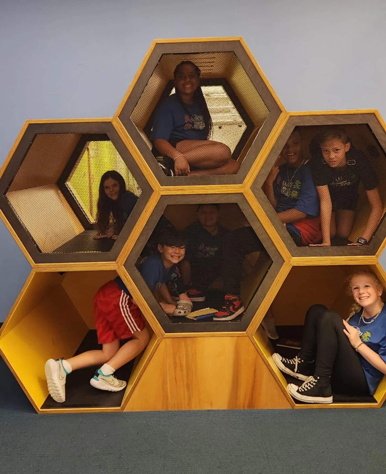 Summer camp kids playing in honeycomb structure in Waco Texas