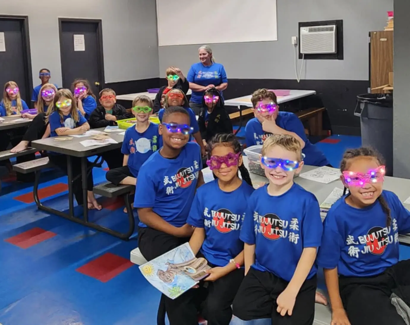 Summer camp kids smiling with light-up glasses at Central Texas Martial Arts